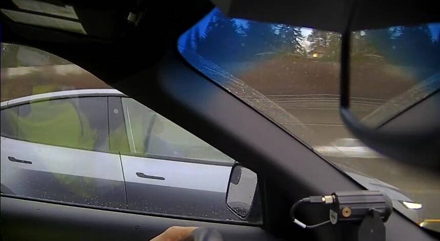 <who>Photo Credit: BC Highway Patrol</who>A screenshot of police video shows the driver who was allegedly asleep at the wheel during rush-hour traffic.